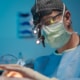 Dr. Richard Balikian performing a preservation deep plane facelift using surgical loupes during facial plastic surgery, demonstrating the precision and anatomical focus required for natural facial rejuvenation.