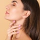 Side profile of a young woman with smooth skin and a defined jawline, gently touching her neck — representing results from a deep vertical neck lift