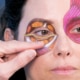 Close-up of eyelid anatomy demonstration with painted muscles and fat compartments
