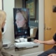 Dr. Richard Balikian reviews a patient's 3D facial analysis during a deep plane facelift consultation, explaining facial aging and natural treatment options.