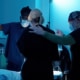 Patient being supported by Dr. Richard Balikian and the surgical team while walking to the operating room before a deep plane facelift, illustrating personalized care, reassurance, and preparation before facial rejuvenation surgery.